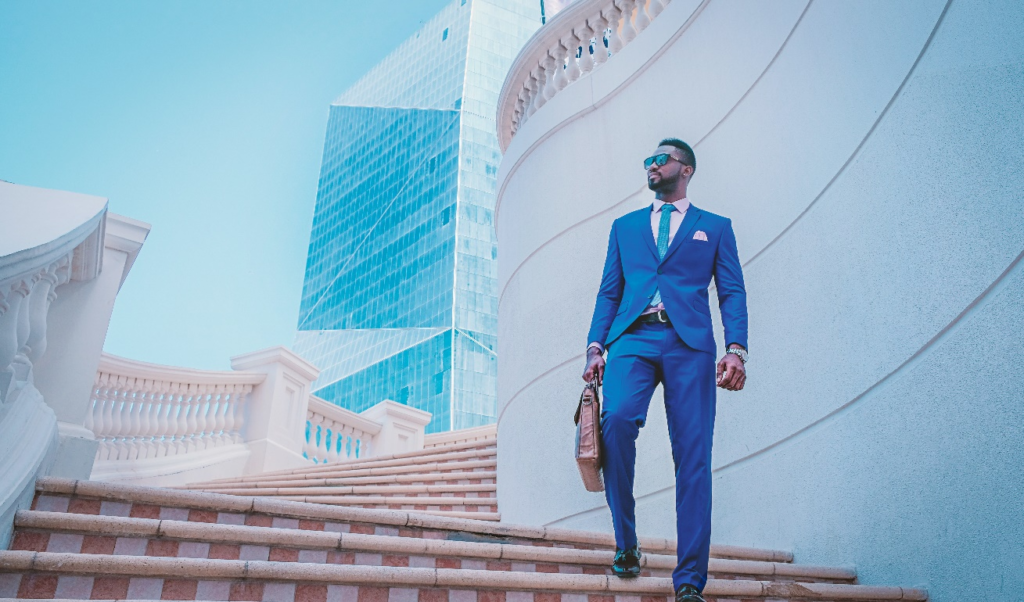 A person in a suit standing on the stairs