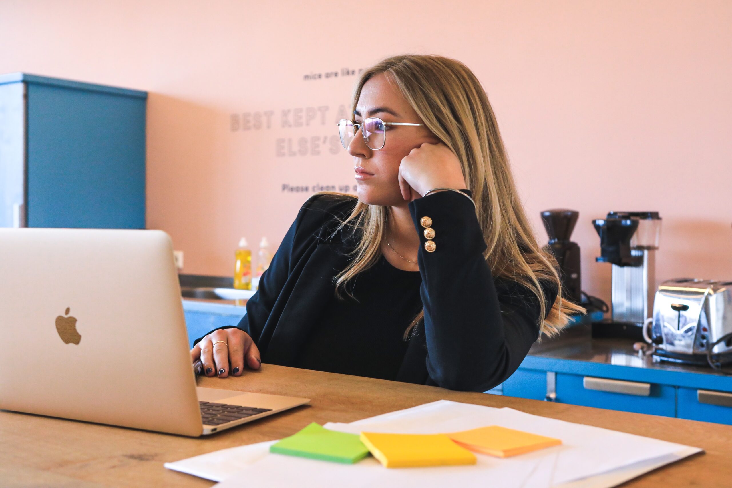 woman in a toxic workplace, bored at laptop