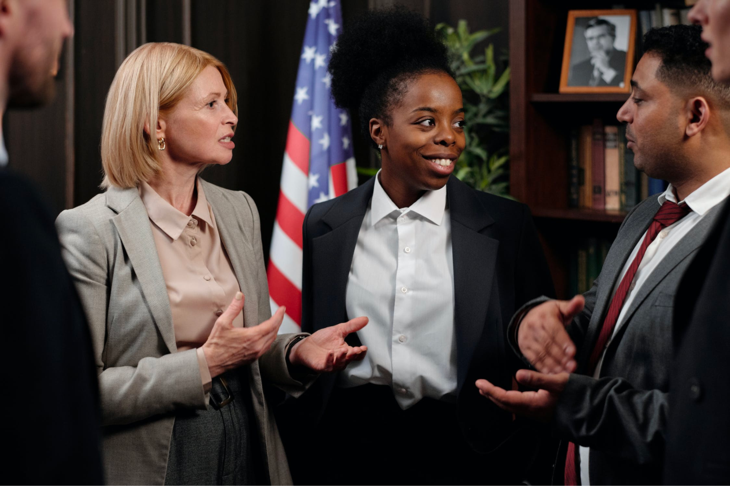 A group of paralegals talk and communicate during a meeting